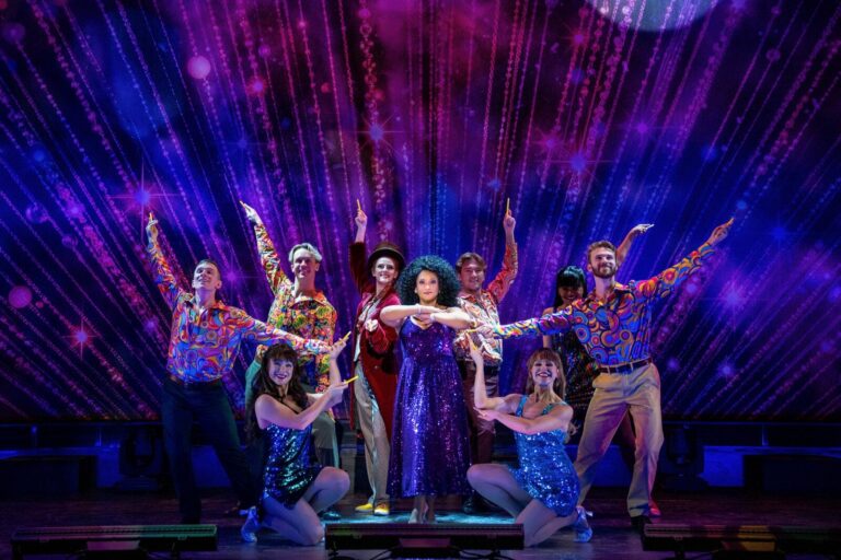 Rema Webb and the ensemble in Bill Pay The Musical